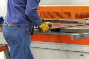 Worker measuring an aluminium blade